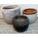 Two white ceramic pots, 12 1/2" x 14" diameter and 9" x 10" diameter approx, and one black pot,