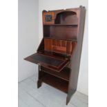 An Arts & Crafts bureau bookcase with a leaded glass door,