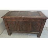 An early 18th century oak panelled coffer with carved front,