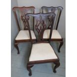 Three Chippendale design dining chairs, with cream upholstered drop in seats,