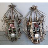 A pair of early 20th century wrought iron hanging candle holders,