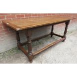 A late 19th/20th century oak refectory dining table with a planked top,