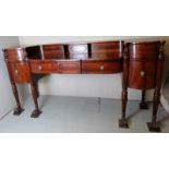 A George III Irish flame mahogany sideboard of impressive size, with three central drawers,