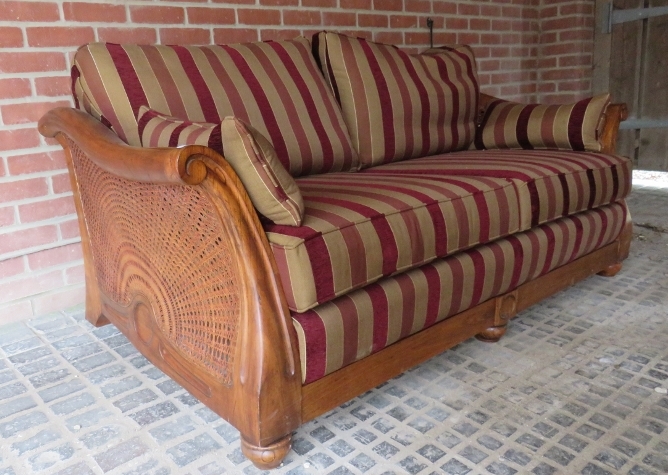 A mid/late 20th century bergere two seater sofa with red, pink and fawn,