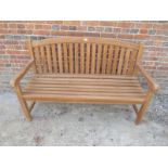 An Indonesian teak garden bench in good condition,