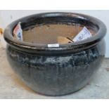 A large black ceramic garden pot,