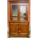 A 19th century French honey oak bookcase with double glass fronted doors over 2 small drawers and