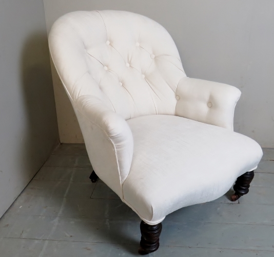 A c1900 cream upholstered armchair,