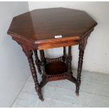 An Edwardian octagonal occasional table in mahogany with a shelf beneath,