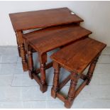 A 20th century nest of three oak tables,