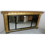 A 19th century gilt gesso overmantle wall mirror with lion mask decoration and ebonised reeded trim