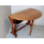 A c1900 satin walnut oval Sutherland table, with detailed carved ends,