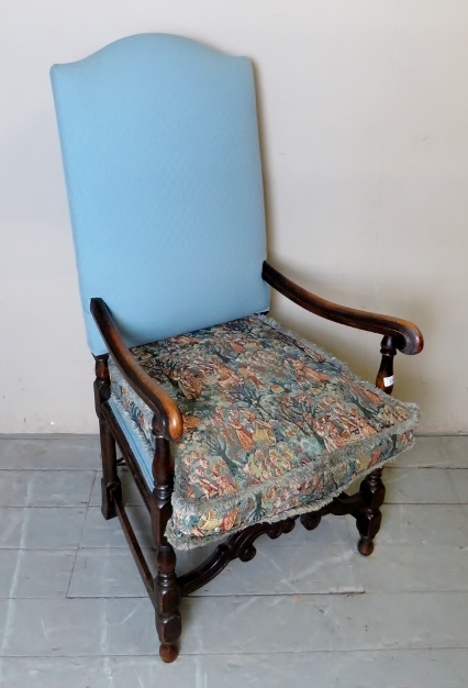 An early 20th century Dutch design, high back elbow chair, upholstered in pale blue,