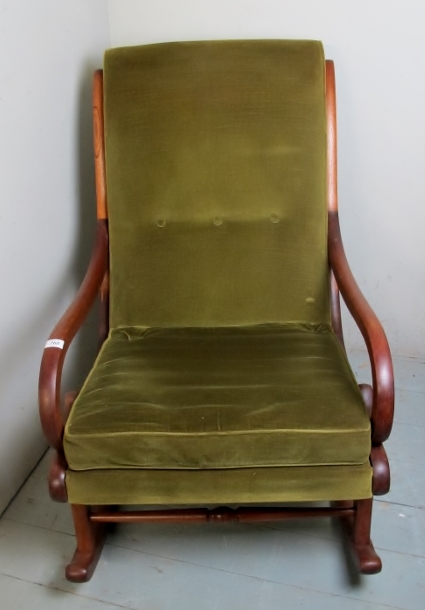 A late Victorian mahogany rocking chair not in a green velour material,