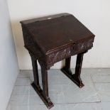 An early 18th century carved oak bible box on later stand, with iron butterfly hinges,