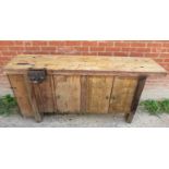 A stripped freestanding work bench with a vice to one side and cupboards est: £80-£120