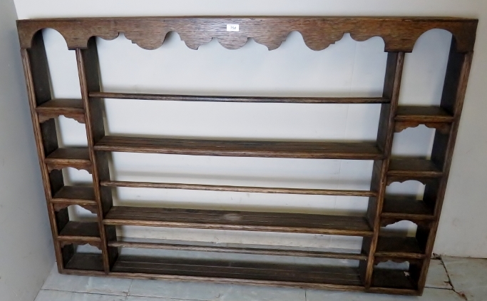 An early 20th century oak wall mounted plate/spice rack est: £50-£80