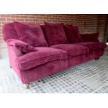 A large comfortable three seater sofa, upholstered in a soft maroon, duck feather filled upholstery,