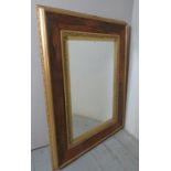 A late 19th/20th century rosewood and gesso wall mirror, in good condition,