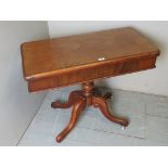 A Victorian mahogany turn over card table with a burgundy baize,