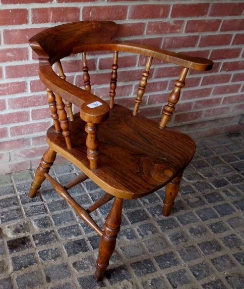 A 19th Century elm seated captain's chair with turned spindles to back est: £30-£50