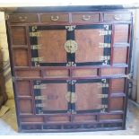 A 20th century Korean cabinet with 4 small drawers over central cupboards,