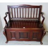 A c1900 mahogany two seater settle with lift up seat for storage and a loose cushion seat est: