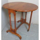 A very pretty 19th century satinwood Aesthetic Period drop leaf table, with oval top,