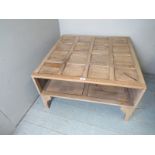 A mid 20th century pale oak panelled coffee table with storage,