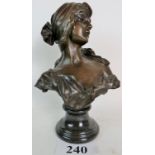 A contemporary bronzed bust of a lady in