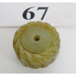 A celadon jade carving of a pleated disc