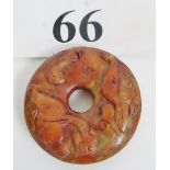 A russet jade carving of a Bi disc with