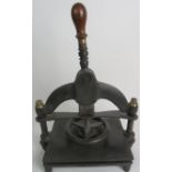 A 19th century cast iron, brass and wooden book press.