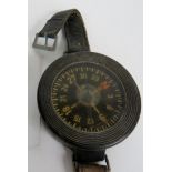 A vintage German liquid filled compass on a wrist-strap, probably military,