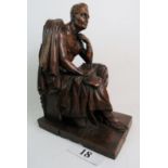 A large decorative carved wooden sculpture of a seated ancient male figure 'Talma', signed 'R.