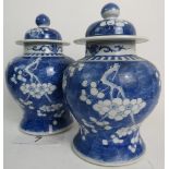 A matched pair of antique Chinese blue and white porcelain vases and covers,