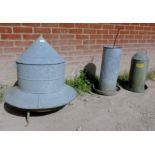 A galvanized chicken feeder and two wate