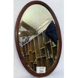 An Edwardian mahogany framed oval bevell