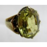 A green sapphire, 12 mm x 16 mm, gold ri
