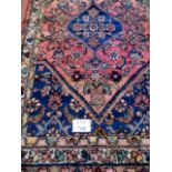 A 20th century Persian wool rug with cen