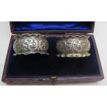 A pair of silver embossed napkin rings,