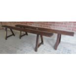 A pair of rustic oak long benches, each