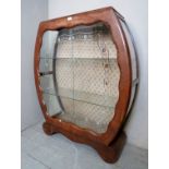 An Art Deco walnut display cabinet with