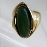 A 9ct gold ring set with green semi-prec