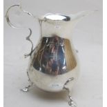 A silver jug with double scroll handle a