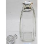 A plain glass decanter with silver colla