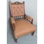 A Victorian fireside armchair upholstere