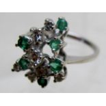 An 18ct white gold diamond and emerald c