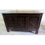 An antique carved oak coffer, 28" x 47",