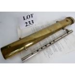 A 19th century brass fife case bearing engraved arms of the East India Company,